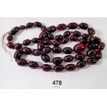 A long cherry amber bead necklace, 105cm long