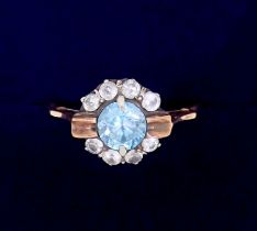 An unmarked gold ring set blue topaz and diamond cluster, size M