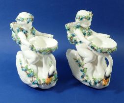 A pair of Victorian cherub and swans groups encrusted with flowers, 22cm high