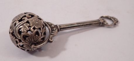 A silver plated rattle with bell to floral pierced roller