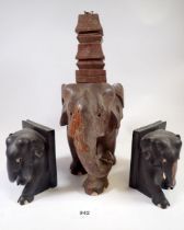 An Indian carved wood elephant and temple table lamp and two ebony elephant bookends (lamp 34cm