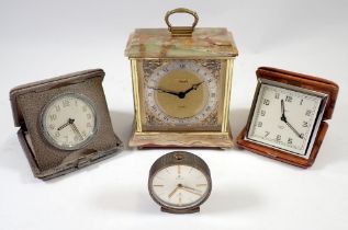 Two vintage travel clocks, a Cyma eight day alarm and an onyx mantel clock by Assisoff
