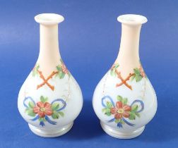 A pair of floral painted opaque glass vases, 15cm