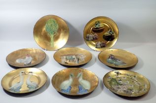 Eight decorative printed gilt dishes, 24cm diameter