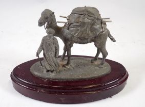 A spelter model of a Middle Eastern man and camel, 19cm wide