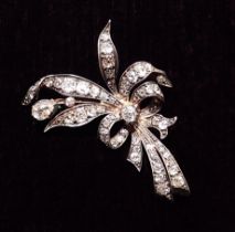 An antique yellow and white gold spray brooch set diamonds to tied ribbons and leaves, 13g, 6cm x