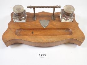 A Victorian oak desk stand with two glass inkwells, 26cm wide