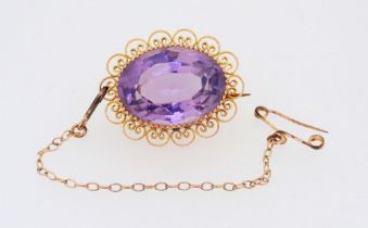 A 9 carat gold oval filigree mounted amethyst brooch, 2.5cm, boxed