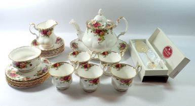 A Royal Albert Country Roses tea service comprising teapot, five cups and six saucers, milk jug,