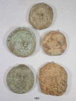 A set of five plaster cast circular wall plaques of classical men