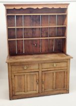 An 18th century elm and pine Welsh dresser with three tier back over two short drawers and two