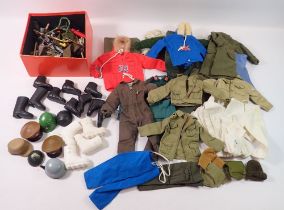 A group of vintage Palitoy Action Man clothing and accessories inlcuding red and blue parkas, flight