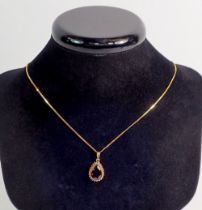A 9 carat gold garnet set pendant, 13mm drop and chain 44cm long - boxed