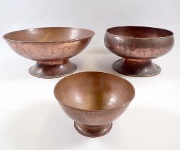 Three various copper bowls, largest 23cm diameter