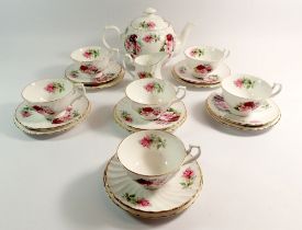 A Royal Kendal floral tea service comprising teapot, six cups and saucers, jug and six tea plates