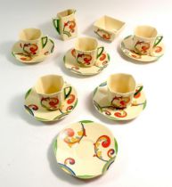 A Royal Doulton Art Deco coffee set with scrollwork and rainbow decoration comprising jug, sugar,