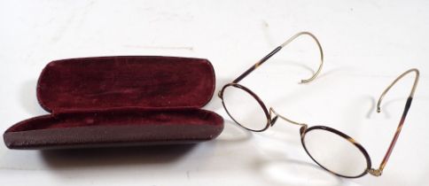 A pair of tortoiseshell and gilt metal spectacles, cased