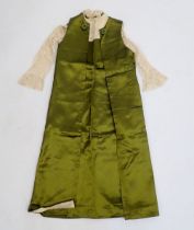 A childs green satin and lace dress with sleeveless jacket