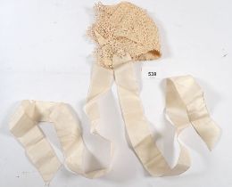 A 19th century tatted lace over silk babies bonnet