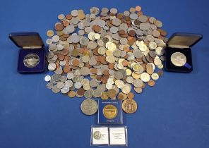 A group of world coins and commemorative tokens including The Tower Mint Warwick Castle and