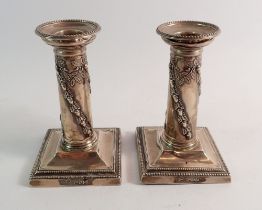 A pair of silver candlesticks with acorn swags, London 1899, Thomas Bradbury & Sons, 12cm tall