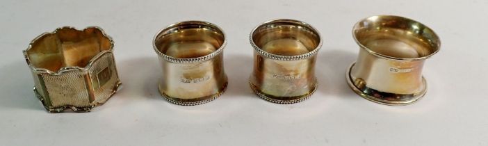 A pair of silver napkin rings, Birmingham 1945 by Henry Williamson Ltd plus two others - total