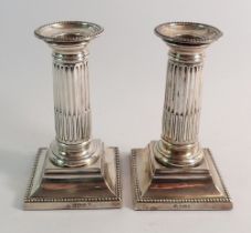 A pair of silver column form candlesticks, 13.54cm tall, Sheffield 1904 by Martin, Hall & Co