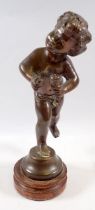 A bronze figure of cupid on stand, 26cm tall