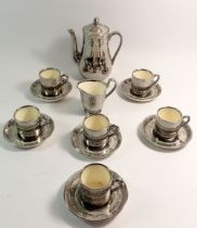 A Minton silvered coffee set comprising coffee pot, cream jug and six cups and saucers