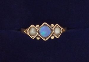 A Victorian 9 carat gold ring set moonstone flanked by two pearls, size K, 1.7g