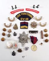 A box of Worcester Regiment badges and insignia