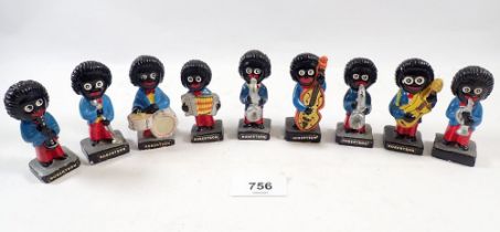 A group of Robertson jam plaster band figures plus Robertson's paper bag and paper tokens