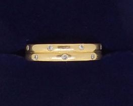 An 18 carat gold ring inset small diamonds, Birmingham 2001 makers mark C, G & S, 4.3g, size K
