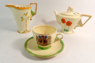 A Clarice Cliff QEII commemorative cup and saucer, an Art Deco Burleigh Ware teapot and a Zenith