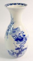 A Japanese blue and white vase painted flowers and trees with two birds, 23cm