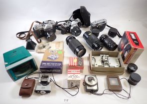 A box of camera equipment including OMI with 50mm lens, etc.