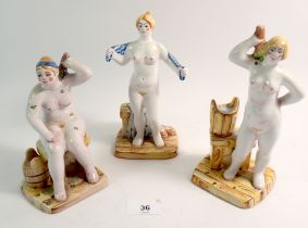 Three Russian pottery figures of nude women bathing, 19cm