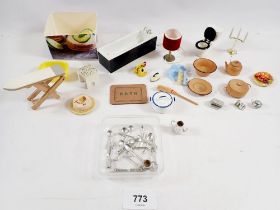 A box of dolls house accessories and bathroom fittings, tea ware, cutlery etc.