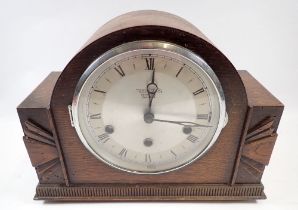 An oak 1930's striking mantel clock retailed by Townsend's of Hereford