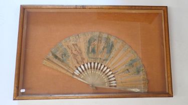 An antique fan with printed decoration on wooden stick a/f, framed and glazed 39 x 62cm