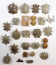 A collection of Scottish military insignia, head-dress, collar badges, shoulder titles etc. black