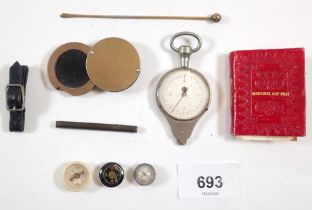 A box of collectables including three miniature compasses, gemological eye glass, mapping tool and