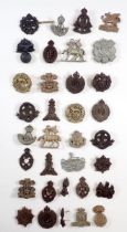 A collection of 30 WWII plastic economy head dress badges, The Buffs, Glosters, The Welsh, Royal