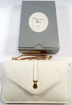 A Christian Dior white leather handbag with logo design in original box, (at present this purse