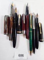 A collection of six fountain and ballpoint pens including Parker