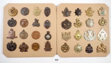 A carded display of 32 Canadian military cap badges including many officers training colleges etc,