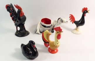 Three retro pottery cockerels, an Italian stylised dog pot and Dartmouth swan, largest 17cm