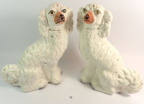 A large pair of Victorian Staffordshire dogs, 31cm tall