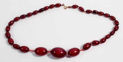 A Bakelite cherry amber necklace, largest bead 2.7cm