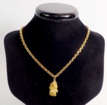 A 22 carat rough cut gold nugget and chain, total weight 55.9g, chain 50cm long